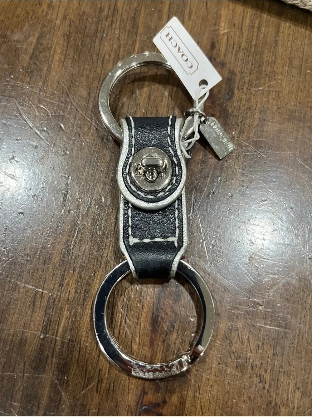 Coach black leather valet keychain.